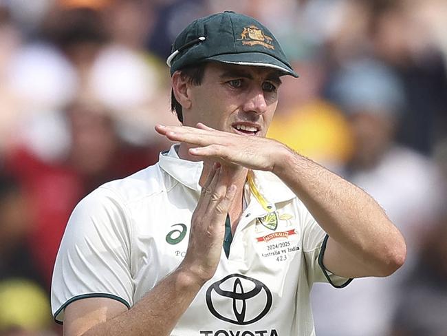 Australia's Pat Cummins signals for a DRS review on day five of the fourth cricket Test match between Australia and India at the Melbourne Cricket Ground (MCG) in Melbourne on December 30, 2024. (Photo by Martin KEEP / AFP) / -- IMAGE RESTRICTED TO EDITORIAL USE - STRICTLY NO COMMERCIAL USE --