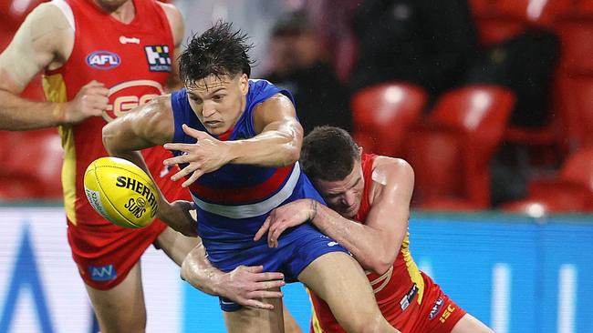 Laitham Vandermeer loses the ball after in a tackle by Pearce Hanley. Picture: Michael Klein