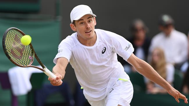 Alex de Minaur of Australia plays a forehand in his loss to Cristian Garin at Wimbledon on Monday. Picture: Getty Images