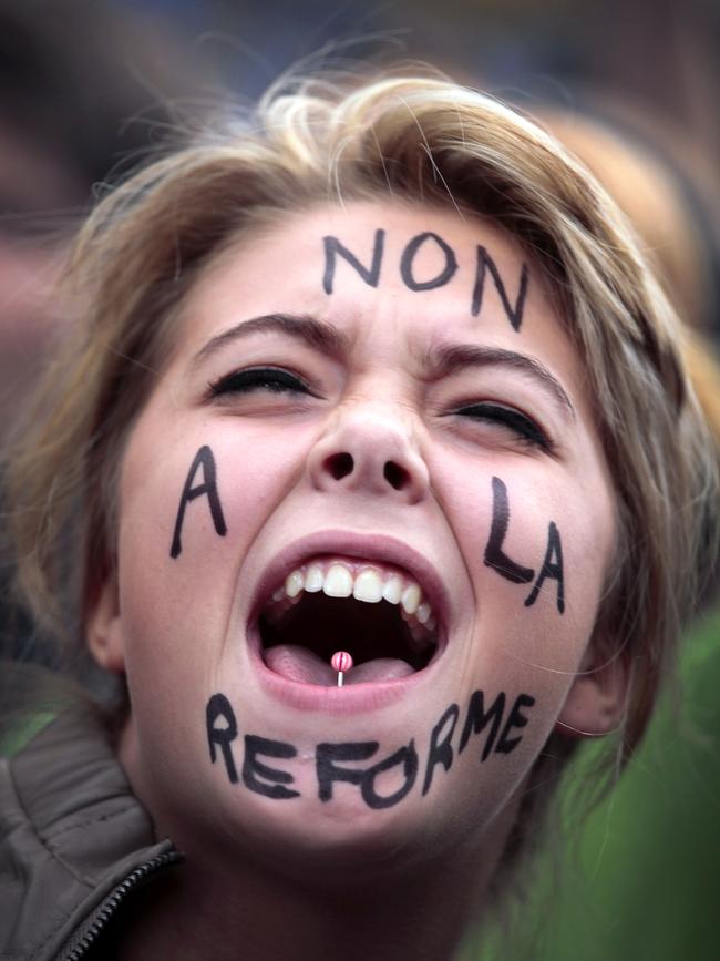 A student shoots slogans as she demonstrates in Paris.