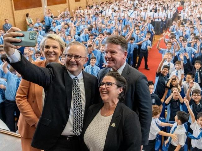 Prime Minister Anthony Albanese takes a selfie with principal Kerrie McDiarmid (right) and students at his alma mater, St Mary's Cathedral College.