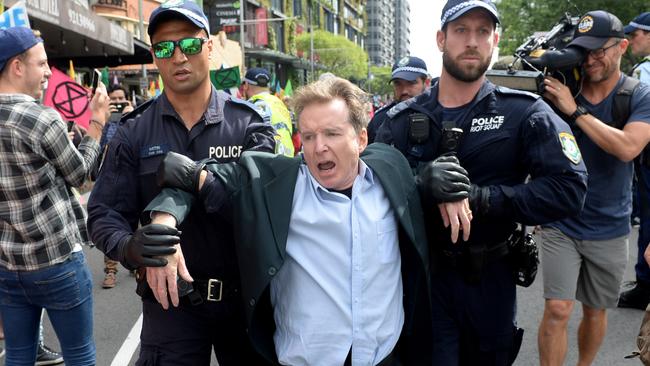 Protesters are removed and arrested during an Extinction Rebellion protest in Sydney, Monday, 7 October, 2019. The Extinction Rebellion climate protests movement has planned a "spring rebellion" from Monday to Sunday, including marches aimed at blocking traffic. (AAP Image/Jeremy Piper) NO ARCHIVING