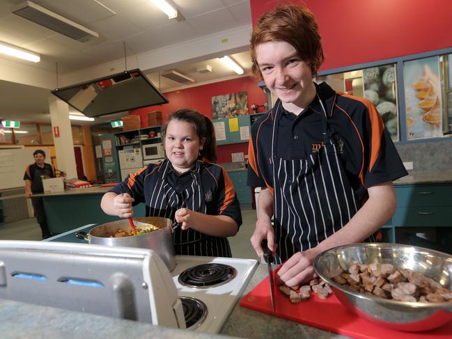 BYLINE - LUKE BOWDEN: Montrose Bay High School cooking students, Sarah Vidler, 13 and Rhys Robinson, 15 cooking meals that will be distributed by Second Bite.