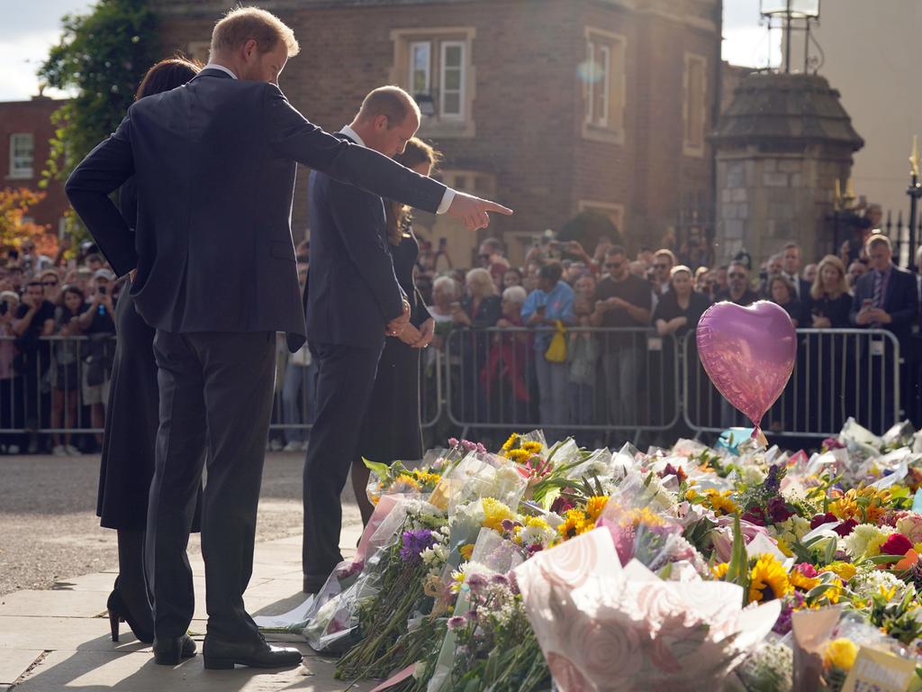 The quartet looked at the sea of floral tributes left for the Queen and spoke to royal fans outside Windsor Castle. Picture: Getty Images.