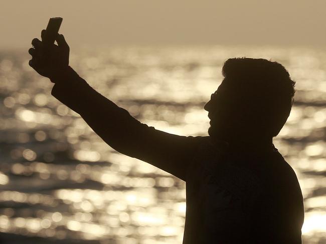 In this Feb. 22, 2016, photo, an Indian man takes a selfie in Mumbai's coastline. India is home to the highest number of people who have died while taking photos of themselves, with 19 of the world’s 49 recorded selfie-linked deaths since 2014, according to San Francisco-based data service provider Priceonomics. The statistic may in part be due to India’s sheer size, with 1.25 billion citizens and one of the world’s fastest-growing smartphone markets. (AP Photo/Rafiq Maqbool)