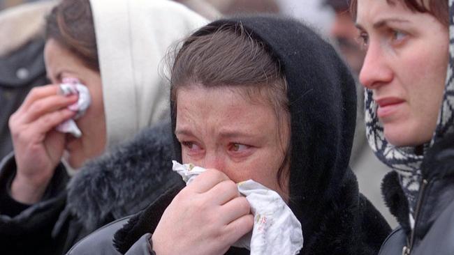 Chechen refugee women weep while standing at border post as they wait for relatives or news from inside Chechnya in 1999. Picture: AP