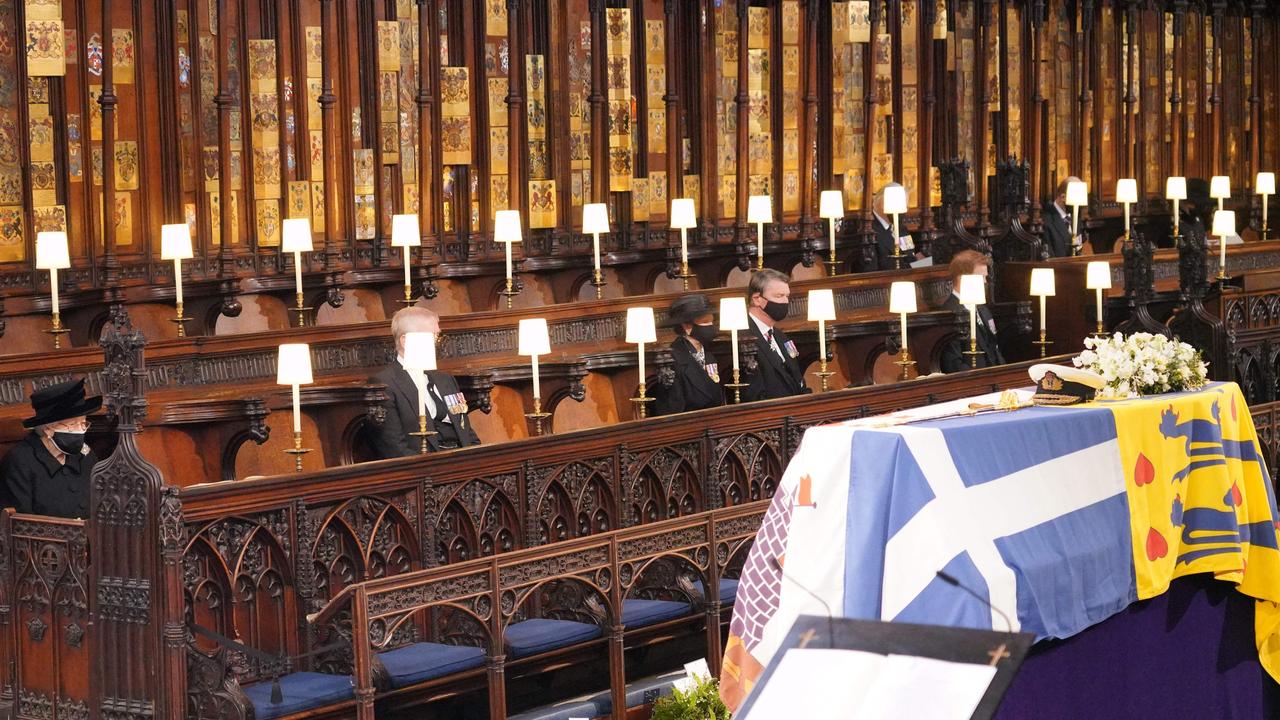 The Queen sits alone as she looks upon her husband’s coffin. Picture: AFP