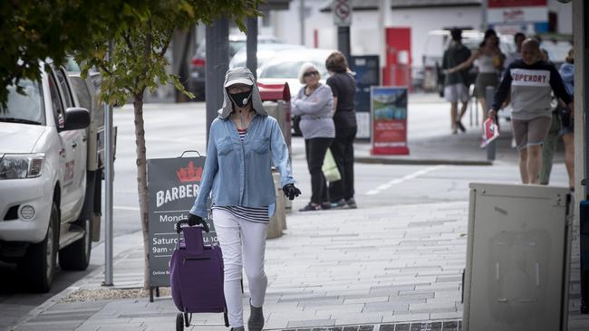 A person walking through Sandy Bay's shopping district wearing a mask. Picture: LUKE BOWDEN