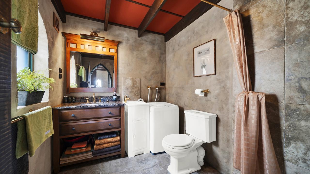 A very royal-looking bathroom and European laundry.