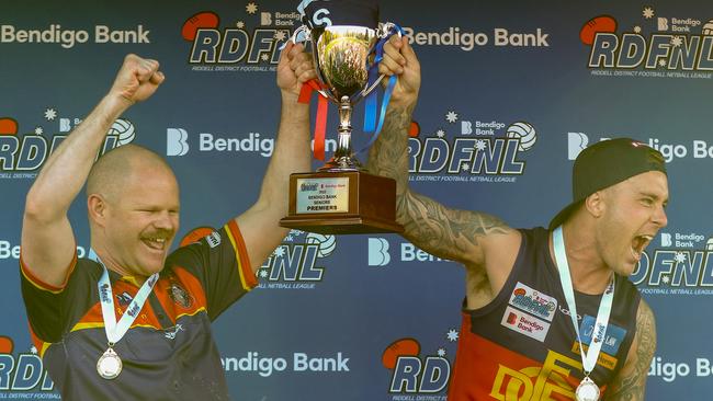 Diggers Rest coach Jamie Lobb and captain Mitch Jensen lift the RDFNL premiership cup. Picture: Aaron Cook