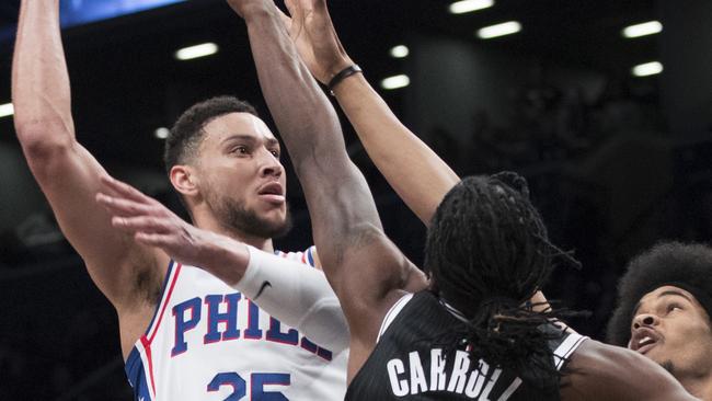 Simmons goes to the basket against Brooklyn’s DeMarre Carroll and Jarrett Allen.