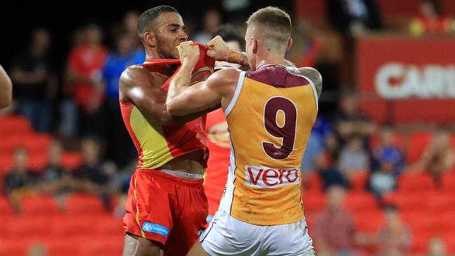 Touk Miller and Dayne Beams scuffle at Metricon Stadium. Picture: Adam Head