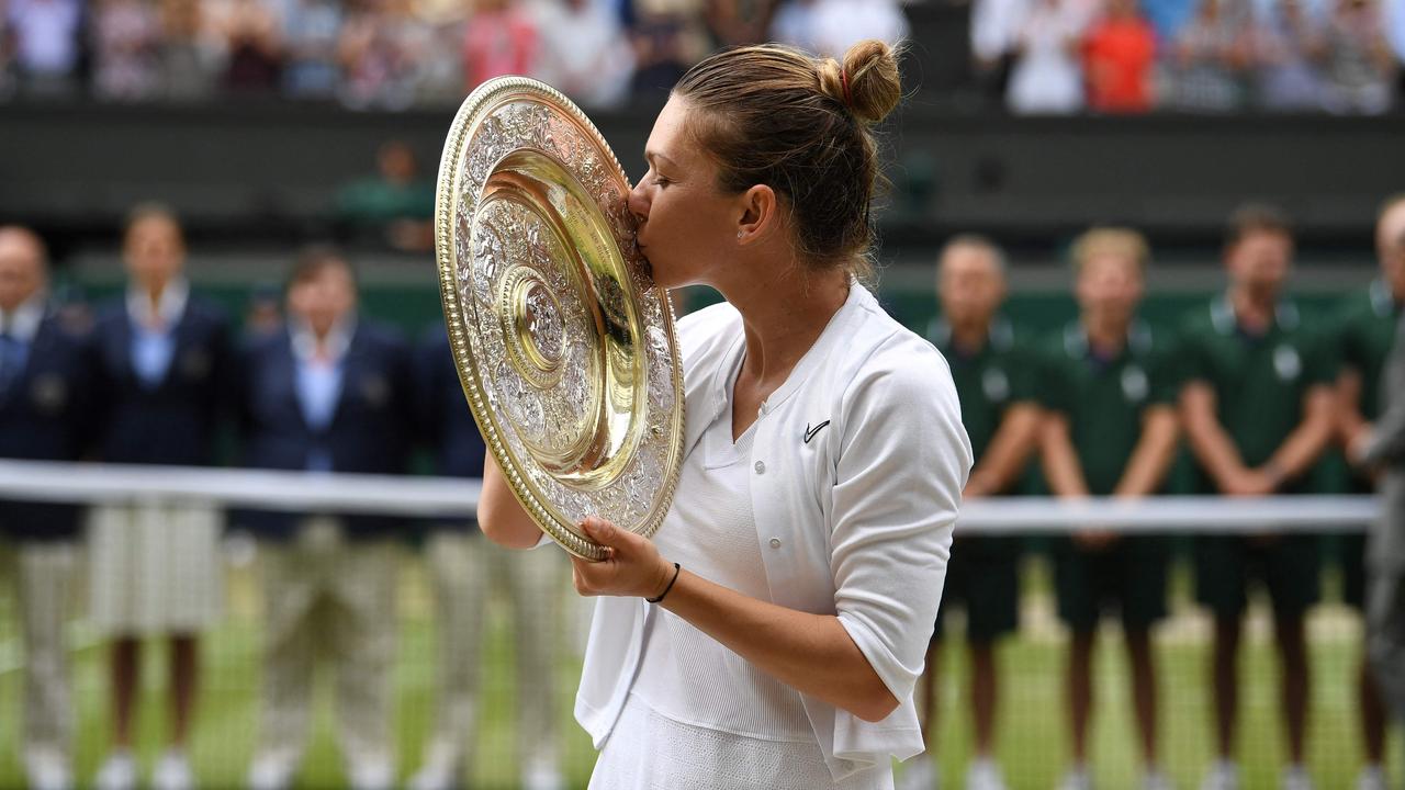 Simona Halep kisses the Venus Rosewater Dish trophy after beating Serena Williams at the 2019 Wimbledon Championships. (Photo by Ben STANSALL / AFP)