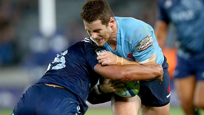 Waratahs flyhalf Bernard Foley takes on the Blues defence at Eden Park.