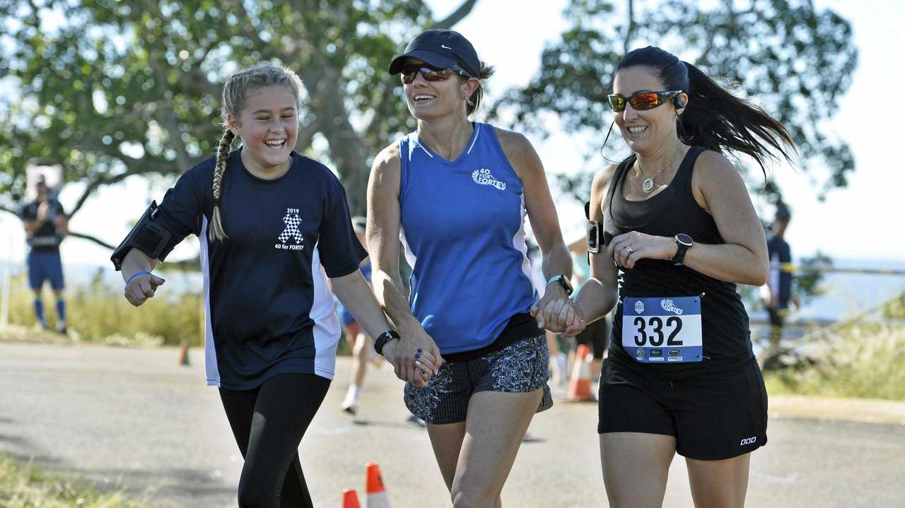 DOIN&#39; IT FOR FORTEY: Suzie Forte (centre) finishes with her niece Pyper and sister-in-law Katy Forte in the second annual 40 for Fortey charity run. Picture: Kevin Farmer