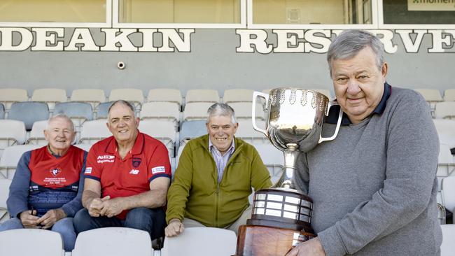 Shepparton United 1974 players, from left, Ross McKellar, coach Des Campbell, Garry Brennan and John Hueston with the cup. Picture: Zoe Phillips