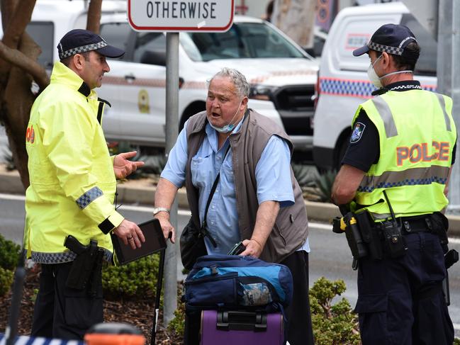 Graham McKerlie is removed from a bus at the Queensland border before being transported to hospital. Picture: Steve Holland/NCA NewsWire