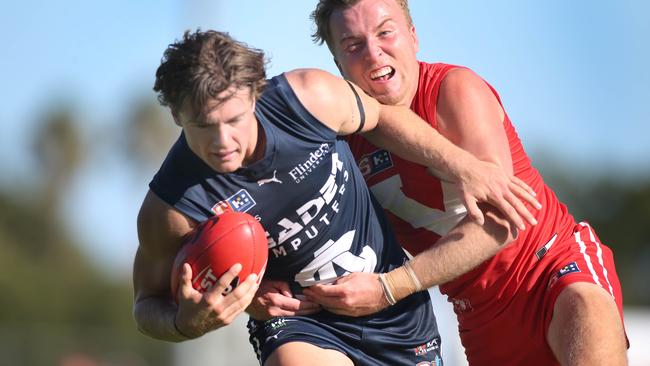 South Adelaide’s Jye Menzie tries to break away against North Adelaide at Prospect Oval on Saturday. Picture: Dean Martin.