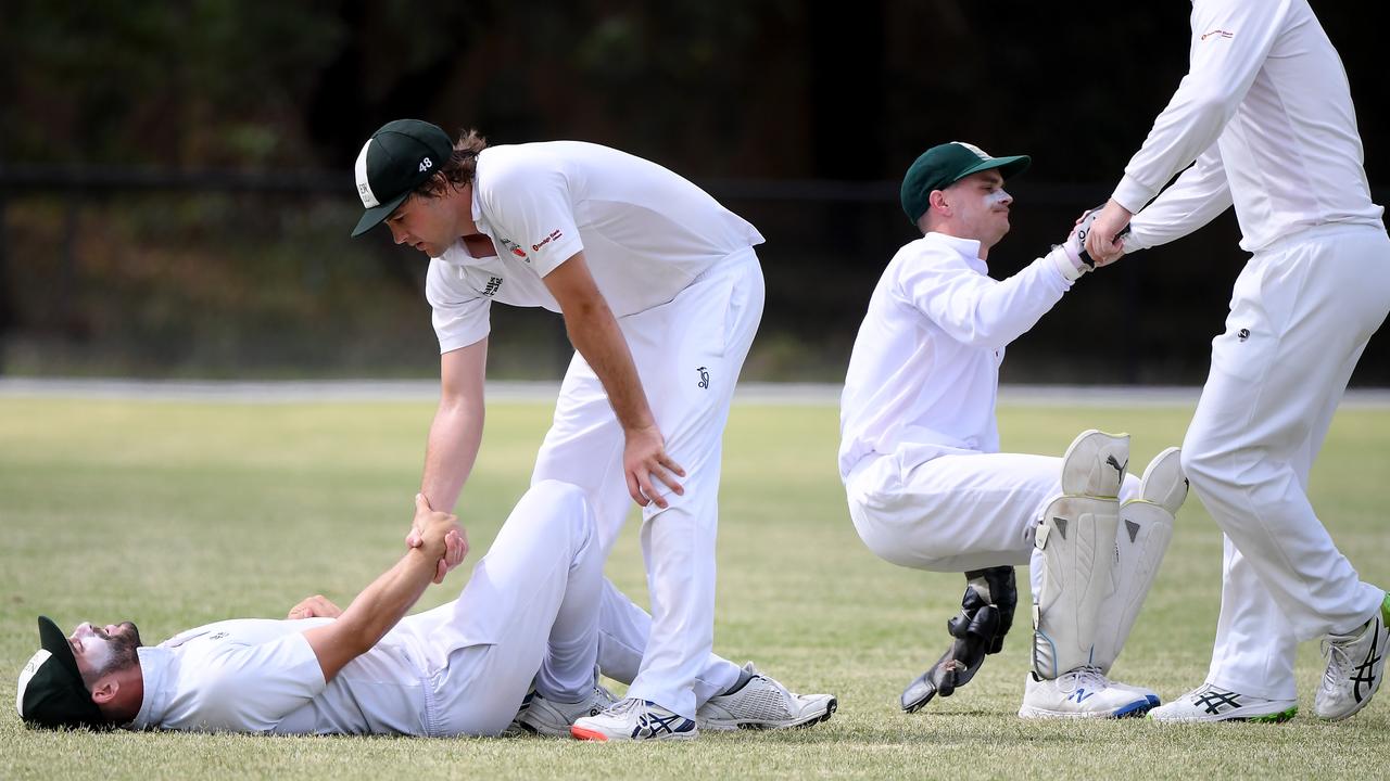 The aftermath as North Eltham Wanderers teammates pick up Adam Tsapatsaris and Jake Hedley. Picture: Andy Brownbill