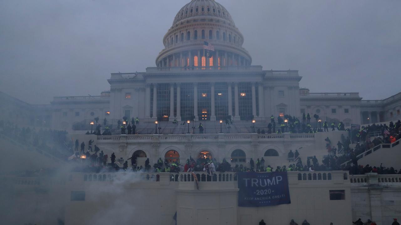 Police officers stand guard as supporters of U.S. President Donald Trump gather in front of the US Capitol Building in Washington, U.S., January 6, 2021. REUTERS/Leah Millis