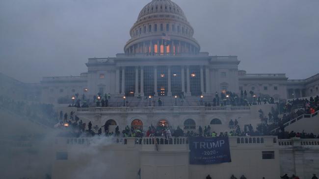 Police officers stand guard as supporters of U.S. President Donald Trump gather in front of the US Capitol Building in Washington, U.S., January 6, 2021. REUTERS/Leah Millis