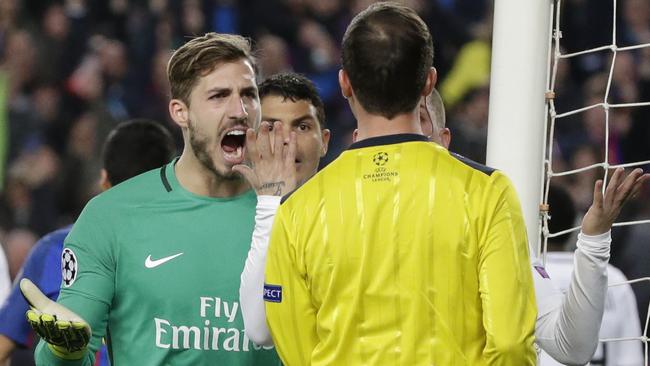 PSG goalkeeper Kevin Trapp, left, argues with the referee Deniz Ayetekin.