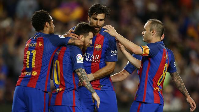 FC Barcelona's Lionel Messi, second left, celebrates after scoring.