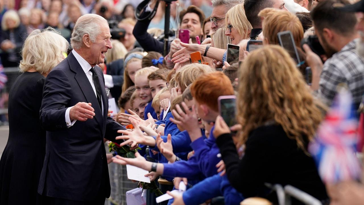 'Camilla, Queen Consort, and King Charles III meet with members of the public during a walkabout in Writers' Square in Belfast. (Photo by Niall Carson / POOL / AFP)