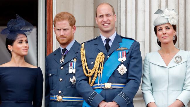 Meghan, Harry, William and Kate watch a flypast to mark the centenary of the Royal Air Force from the balcony of Buckingham Palace in 2018. Picture: Getty Images.