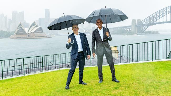 Anthony Albanese, left, meets Barack Obama in Sydney on Monday. The leaders were snapped in the rain hours before the Prime Minister unveiled his deal with the Greens on climate change policy.