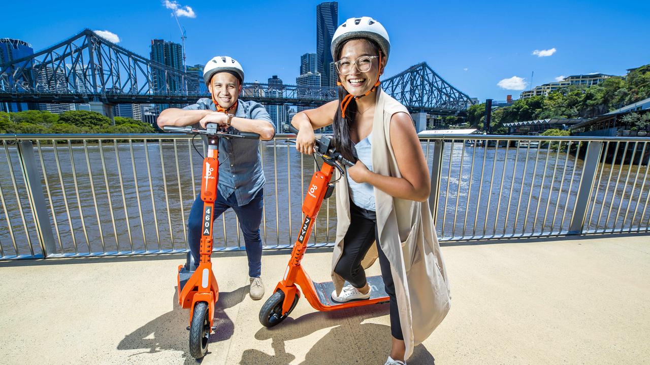 Lorenz Villalba from Bowen Hills and Jairaldine Cruz from Springfield on the way to Howard Smith Wharves on Neuron e-scooters. Picture: Richard Walker