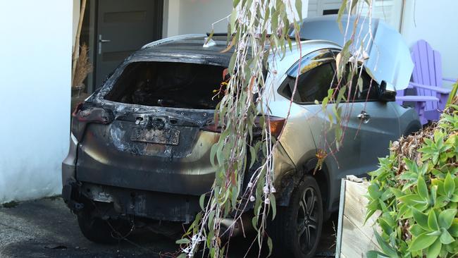 A car destroyed by fire in the driveway of a Jan Juc house in Marner Close. Picture: Alison Wynd