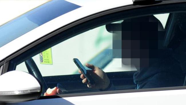 A driver makes no attempt to conceal the phone while driving on Punt Rd.