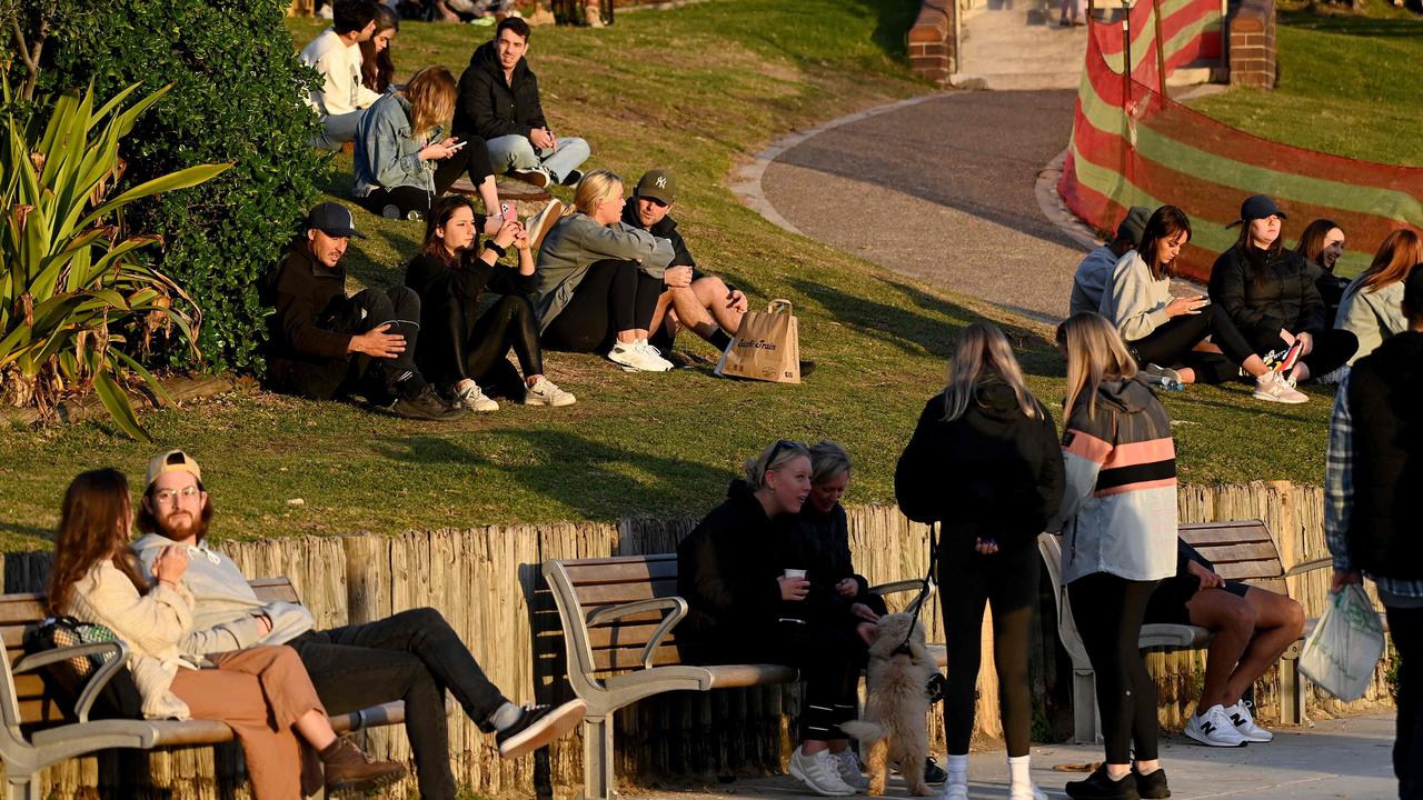 People sit along the grassy area at Bondi Beach in Sydney on July 6, 2021. Picture: Bianca De Marchi / AFP