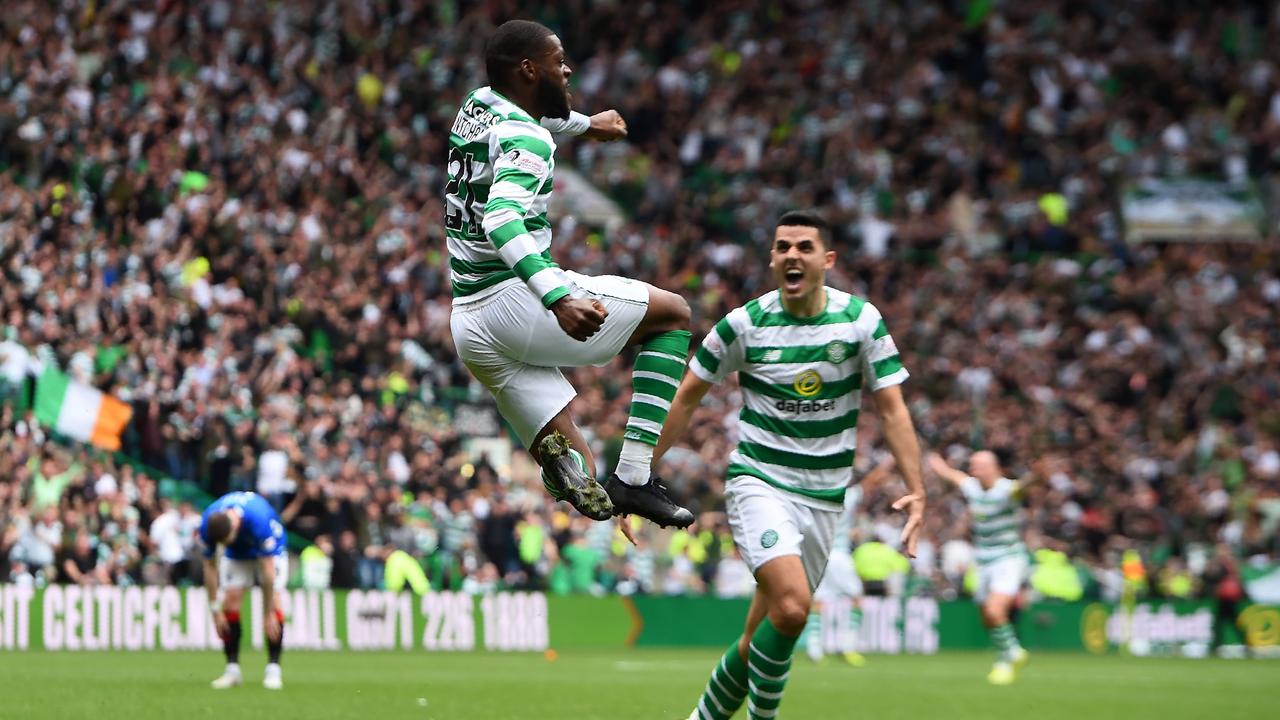 Celtic's Australian midfielder Tom Rogic celebrates with Olivier Ntcham (L).