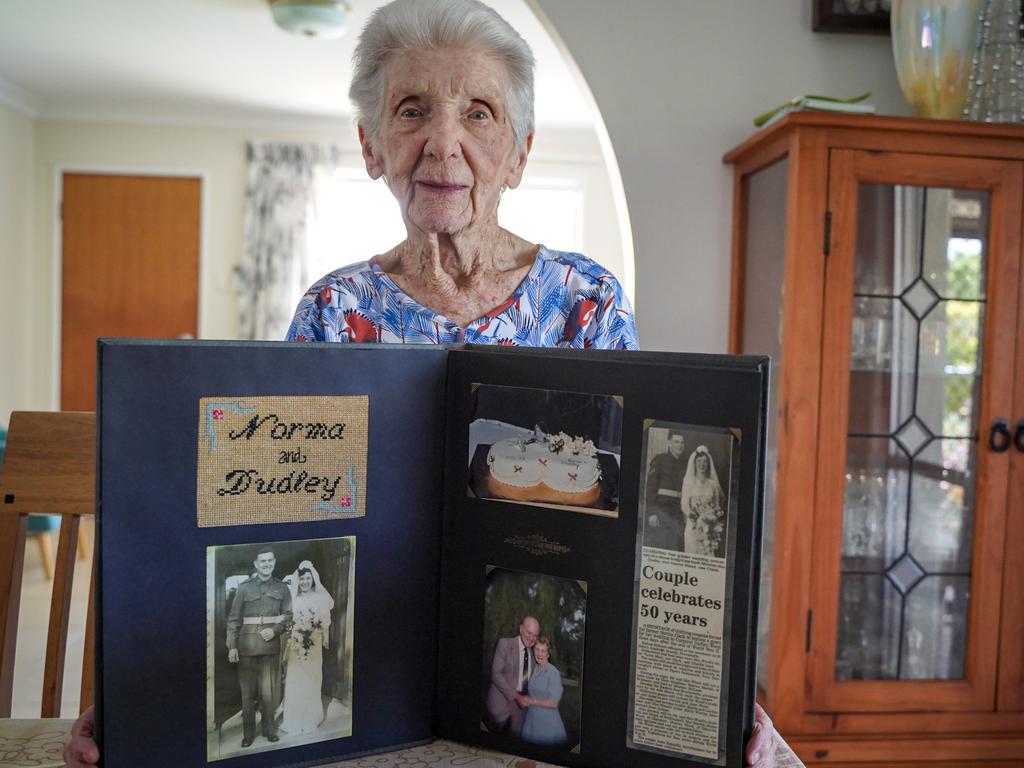 Mackay great-grandmother Norma Wood, who celebrates her 100th birthday on December 1, 2021., cherishes a photo album from her 50th wedding anniversary with late husband Basil Dudley Wood. Picture: Heidi Petith