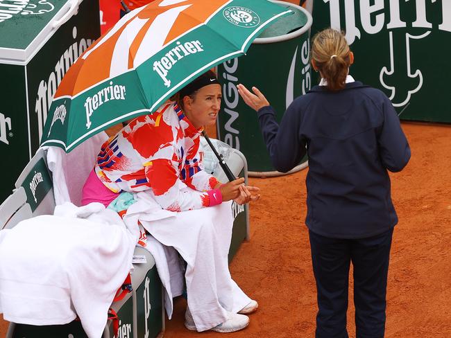 PARIS, FRANCE - SEPTEMBER 27: Victoria Azarenka of Belarus speaks with a match official as she shelters under an umbrella during her Women's Singles first round match against Danka Kovinic of Montenegro during day one of the 2020 French Open at Roland Garros on September 27, 2020 in Paris, France. (Photo by Julian Finney/Getty Images)