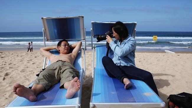 Yan and Chen get snappy at Manly beach. Picture: Toby Zerna