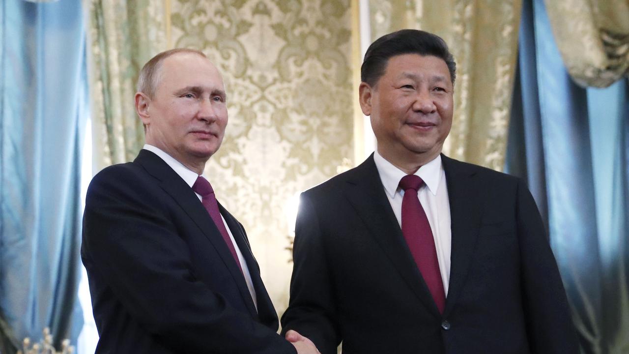 Chinese President Xi Jinping shakes hands with Russian President Vladimir Putin. Picture: AFP PHOTO / POOL / Sergei Ilnitsky