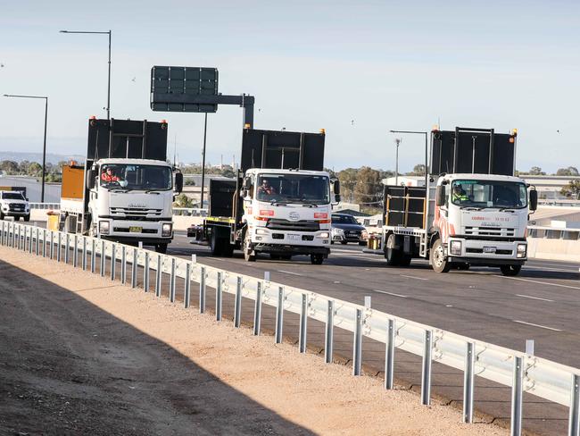 Northern Connector opening , Wade Matthews, project manager from Landlease waves off the first group of vehicles at  the Southern interchange of the Northern Connector at Port River Express Way Image/ Russell Millard