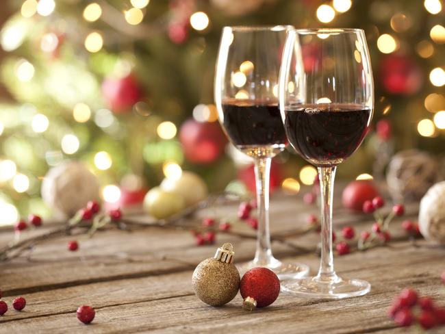 Taste cover.  Red wine on an old wood table in front of a Christmas tree. A glow from the window softly illuminates the tree. Selective focus and shallow depth of filed. Picture: iStock