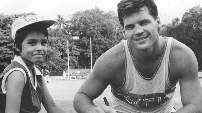 Hawthorn forward Jason Dunstall signs eight-year-old Dean Wilde's cast during a break from training at Gardens in January, 1991.