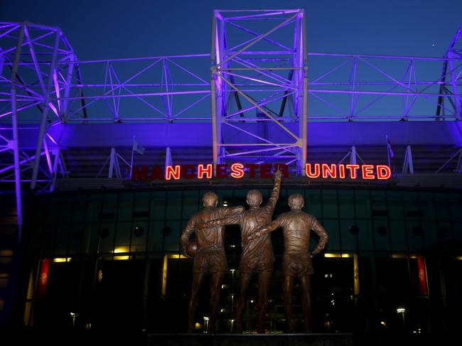 MANCHESTER, ENGLAND - APRIL 16: Old Trafford, the home of Manchester United Football Club displays an NHS UNITED logo on the front entrance of the stadium tonight to honour the Clap for NHS Thursday on April 16, 2020 in Manchester, England. The Coronavirus (COVID-19) pandemic has spread to many countries across the world, claiming over 130,000 lives and infecting more than 2 million people. (Photo by Clive Brunskill/Getty Images)