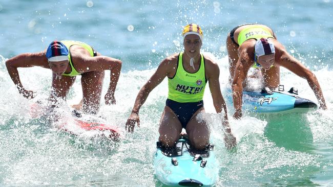 Electra Outram, right, competing in the surf.