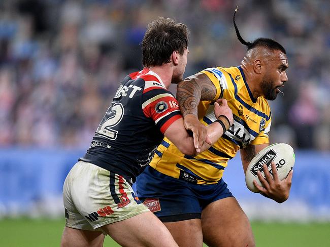 Junior Paulo of the Eels is tackled by Angus Crichton