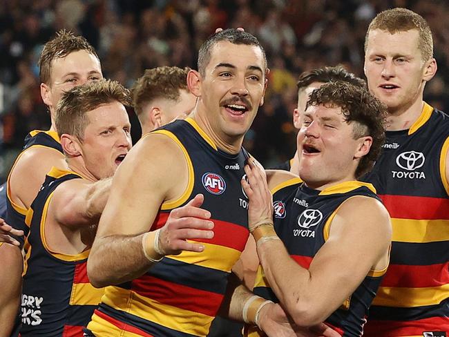 ADELAIDE, AUSTRALIA - JULY 29: Taylor Walker of the Crows winner of the Showdown Medal with team mates during the 2023 AFL Round 20 match between the Adelaide Crows and the Port Adelaide Power at Adelaide Oval on July 29, 2023 in Adelaide, Australia. (Photo by Sarah Reed/AFL Photos via Getty Images)