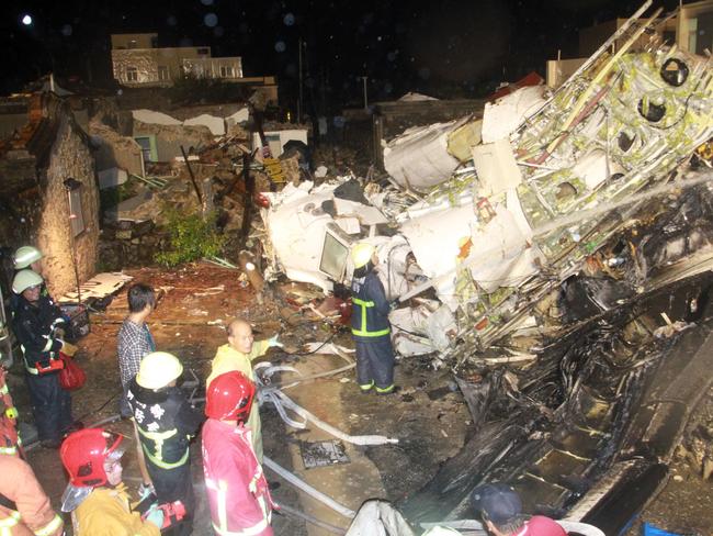 Rescue workers search for survivors after the crash of the TransAsia Airways flight GE222.