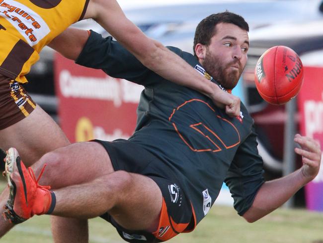 Geelong West Giants player Ted Walliss juggles the ball as he is tackled. The team is chasing its first premiership in the Geelong and District Football League. Picture: Mark Wilson