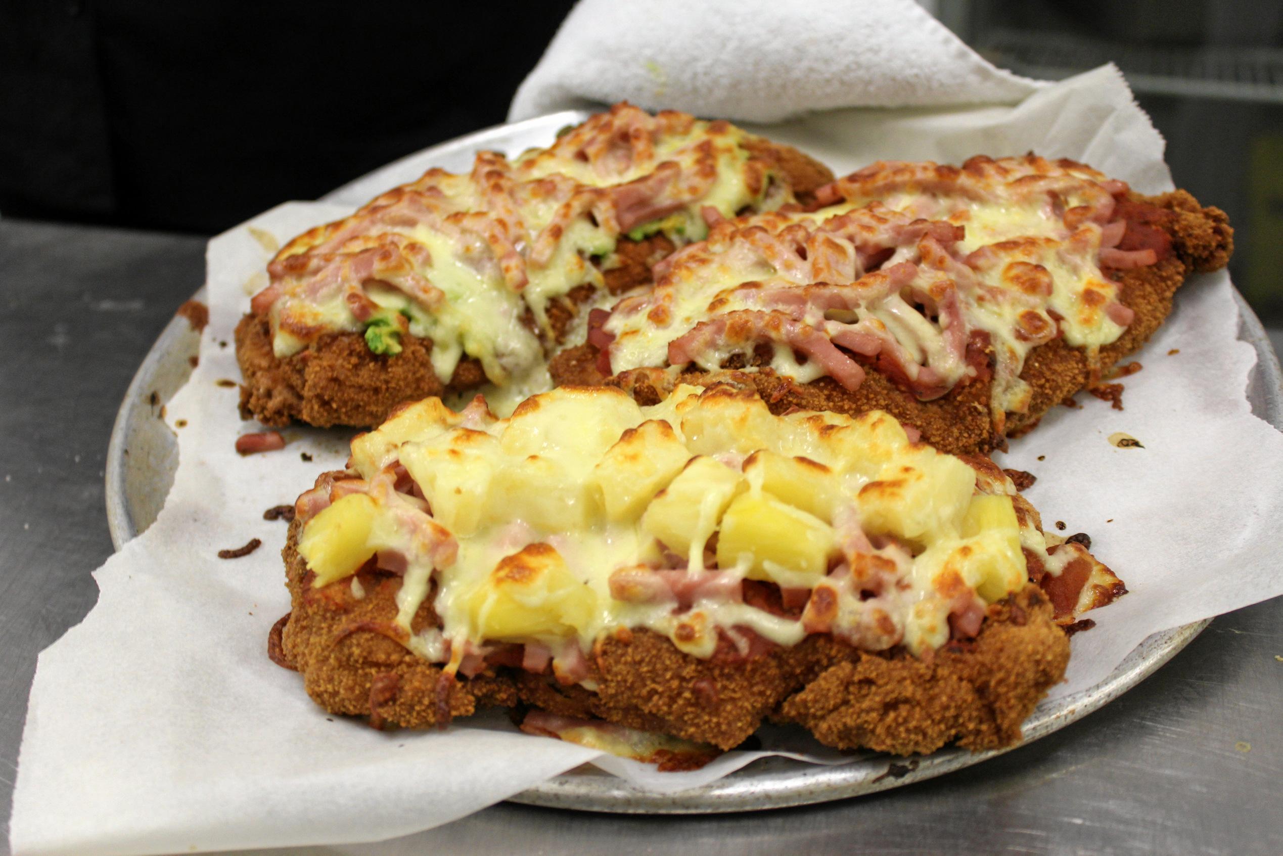 The mouthwatering Hawaiian, Golden Buick and Traditional Chicken Parmies served up at the Royal Hotel in Yarraman. Picture: Laura Blackmore