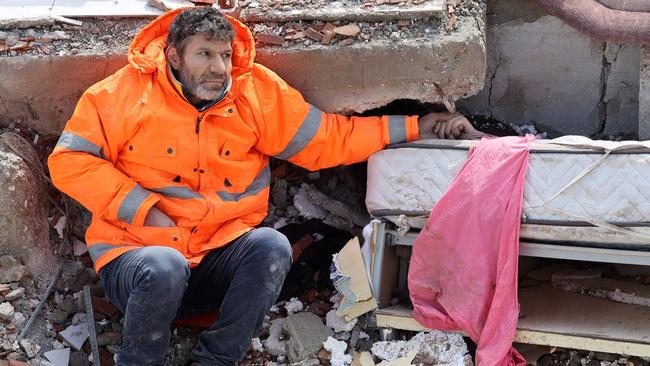 Mesut Hancer holds the hand of his 15-year-old daughter, Irmak, who died in the earthquake in Kahramanmaras, close to the quake's epicentre. Picture: Adem Altan/AFP